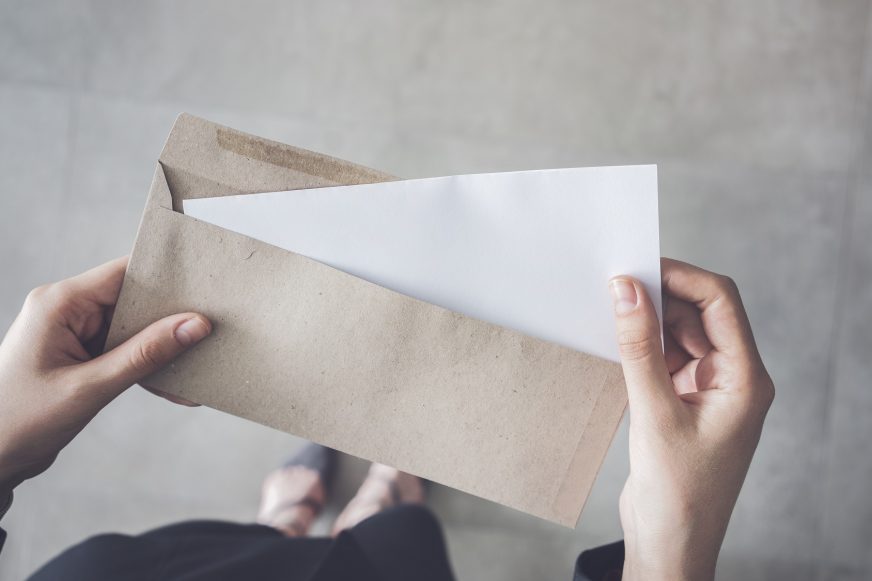 someone holding brown envelope